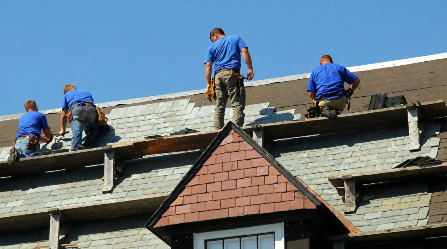 Roof replacement in progress with a team of professional contractors installing new shingles on a residential home in Honolulu, HI